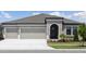 Beautiful single Gathering home featuring a two car garage, manicured lawn and modern architectural details at 5194 Everlong Dr, Apollo Beach, FL 33572