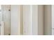 Bright hallway with a glass-door shower and doorways, offering a glimpse into different spaces at 5194 Everlong Dr, Apollo Beach, FL 33572