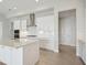 Modern kitchen featuring stainless steel appliances, white cabinets, and a spacious island for cooking and entertaining at 5194 Everlong Dr, Apollo Beach, FL 33572