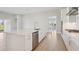 Bright kitchen featuring a large island, stainless steel appliances, and wood floors, perfect for entertaining at 5194 Everlong Dr, Apollo Beach, FL 33572