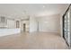 Open-concept living space boasts a modern kitchen and a spacious living area with natural light and tile floors at 5194 Everlong Dr, Apollo Beach, FL 33572