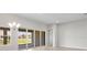 Bright living area featuring sliding glass doors for outdoor access, modern light fixture and wood look floors at 5194 Everlong Dr, Apollo Beach, FL 33572