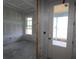 Unfinished living room featuring a new door and two large windows at 5287 Everlong Dr, Apollo Beach, FL 33572