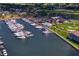 Magnificent aerial view of the marina filled with boats with a clubhouse, pool, and golf course nearby at 5939 Bayview S Cir, Gulfport, FL 33707