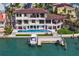 Aerial view of a luxury waterfront home with a pool, dock, and boat lift at 5939 Bayview S Cir, Gulfport, FL 33707