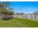 Backyard with a trampoline, lush green grass, and waterfront access at 5939 Bayview S Cir, Gulfport, FL 33707