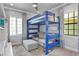 Unique bedroom featuring a lofted bunk bed, natural light, and stylish decor at 5939 Bayview S Cir, Gulfport, FL 33707