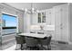 Elegant dining room with modern lighting, large windows, and custom built in cabinets at 5939 Bayview S Cir, Gulfport, FL 33707