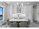 Stunning dining room featuring modern lighting fixtures, a white marble dining table, and custom storage cabinets at 5939 Bayview S Cir, Gulfport, FL 33707