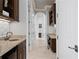 Hallway with wood cabinets, stone counters, and tile flooring leads to an office area at 5939 Bayview S Cir, Gulfport, FL 33707