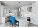 Bright and airy kitchen with white cabinetry, marble countertops, stainless steel appliances, and bar seating at 5939 Bayview S Cir, Gulfport, FL 33707
