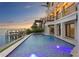 Sparkling pool and jacuzzi with waterfront views from this luxury property at 5939 Bayview S Cir, Gulfport, FL 33707