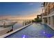 Tranquil backyard pool and dock, with the waterfront offering a seamless transition from relaxation to nautical adventure at 5939 Bayview S Cir, Gulfport, FL 33707