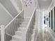 Elegant staircase with patterned steps, decorative metal railing, and wall art at 5939 Bayview S Cir, Gulfport, FL 33707