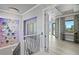 View from staircase to an open hallway with crystal chandelier and water view at 5939 Bayview S Cir, Gulfport, FL 33707