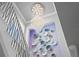 View of staircase with metal railing, decorative wall art, and crystal chandelier at 5939 Bayview S Cir, Gulfport, FL 33707