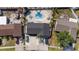 Overhead view of backyard with a kidney-shaped pool, lush landscaping, and lounge chairs at 6428 Moss Way, Tampa, FL 33625