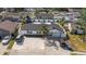 Aerial view of a well-maintained home with a large yard, landscaped with a mature palm in the front yard at 6428 Moss Way, Tampa, FL 33625