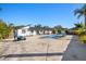 Expansive backyard with a sparkling pool, seating areas, and lush tropical landscaping at 6428 Moss Way, Tampa, FL 33625