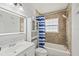 Bathroom featuring a vanity, shower-tub combo, storage cabinet, and decorative wall tile at 6428 Moss Way, Tampa, FL 33625