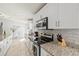 Clean bright kitchen features granite counters, stainless appliances, and tile backsplash at 6428 Moss Way, Tampa, FL 33625