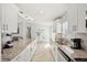 Bright kitchen has sleek white cabinets, granite counters, stainless appliances, and tile backsplash at 6428 Moss Way, Tampa, FL 33625