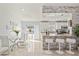 Open-concept kitchen and dining room with breakfast bar and easy access to pool via sliding glass doors at 6428 Moss Way, Tampa, FL 33625