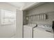 Indoor laundry room features washer, dryer, storage shelves and easy access at 6428 Moss Way, Tampa, FL 33625