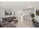 Open-concept living space with tile floors, modern furnishings, and seamless flow to the kitchen at 6428 Moss Way, Tampa, FL 33625