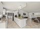 Open-concept living space with view of kitchen, dining area, living room, and laundry room at 6428 Moss Way, Tampa, FL 33625