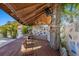 Outdoor bar with wooden countertop, stools, and a covered deck with string lights, perfect for entertaining in style at 6428 Moss Way, Tampa, FL 33625