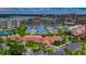 Aerial view of a complex with a waterway, boat docks, pool and lush, tropical landscaping at 7882 Sailboat Key S Blvd # 401, South Pasadena, FL 33707