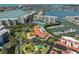 Panoramic aerial of condo community, showcasing pool, tennis courts, marina, and manicured lawns at 7882 Sailboat Key S Blvd # 401, South Pasadena, FL 33707