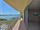 Enjoy water views from this condo balcony with white railings and sliding glass door access to the interior at 7882 Sailboat Key S Blvd # 401, South Pasadena, FL 33707