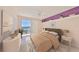 Serene bedroom featuring sliding glass doors to a balcony, offering natural light and a relaxing atmosphere at 7882 Sailboat Key S Blvd # 401, South Pasadena, FL 33707