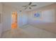 Bright bedroom with a ceiling fan and a view of the bathroom, offering a comfortable and private retreat at 7882 Sailboat Key S Blvd # 401, South Pasadena, FL 33707