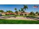 Exterior of building with tile roof, surrounded by tropical trees and an American flag at 7882 Sailboat Key S Blvd # 401, South Pasadena, FL 33707