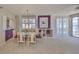 Bright and spacious dining area with plantation shutters, a modern chandelier, and water views at 7882 Sailboat Key S Blvd # 401, South Pasadena, FL 33707