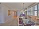 Condo dining area featuring modern furnishings and an open view to the hallway, kitchen, and outdoor balcony at 7882 Sailboat Key S Blvd # 401, South Pasadena, FL 33707