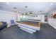 Billiard room with pool tables, comfortable chair and view of the building's exterior at 7882 Sailboat Key S Blvd # 401, South Pasadena, FL 33707