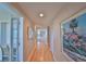 Hallway featuring hardwood floors with views of other rooms, wall art, and a built-in desk space at 7882 Sailboat Key S Blvd # 401, South Pasadena, FL 33707