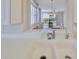 Close-up view of a bright, updated kitchen featuring a stainless steel faucet and sink at 7882 Sailboat Key S Blvd # 401, South Pasadena, FL 33707