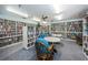 Resident library with books, tables and chairs in a well lit common room for reading and study at 7882 Sailboat Key S Blvd # 401, South Pasadena, FL 33707