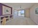Cozy living area with bright natural light, neutral carpeting, built-in shelving, and balcony access at 7882 Sailboat Key S Blvd # 401, South Pasadena, FL 33707