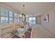 Bright condo dining and living area with plantation shutters, water views, and plush carpeting at 7882 Sailboat Key S Blvd # 401, South Pasadena, FL 33707