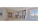 Open-concept living area with neutral colors, plantation shutters, and a view to the kitchen and entry at 7882 Sailboat Key S Blvd # 401, South Pasadena, FL 33707