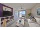 Inviting living room with a large window, comfortable seating, and modern decor, creating a cozy and stylish atmosphere at 7882 Sailboat Key S Blvd # 401, South Pasadena, FL 33707