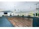 Large meeting room with a dance floor, sliding glass doors to the outdoors, and a ceiling fan at 7882 Sailboat Key S Blvd # 401, South Pasadena, FL 33707