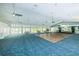 Large meeting room with a dance floor, sliding glass doors to the outdoors, and a ceiling fan at 7882 Sailboat Key S Blvd # 401, South Pasadena, FL 33707
