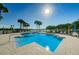 Inviting pool area surrounded by palm trees and lounge chairs, perfect for outdoor relaxation and enjoying sunny days at 7882 Sailboat Key S Blvd # 401, South Pasadena, FL 33707